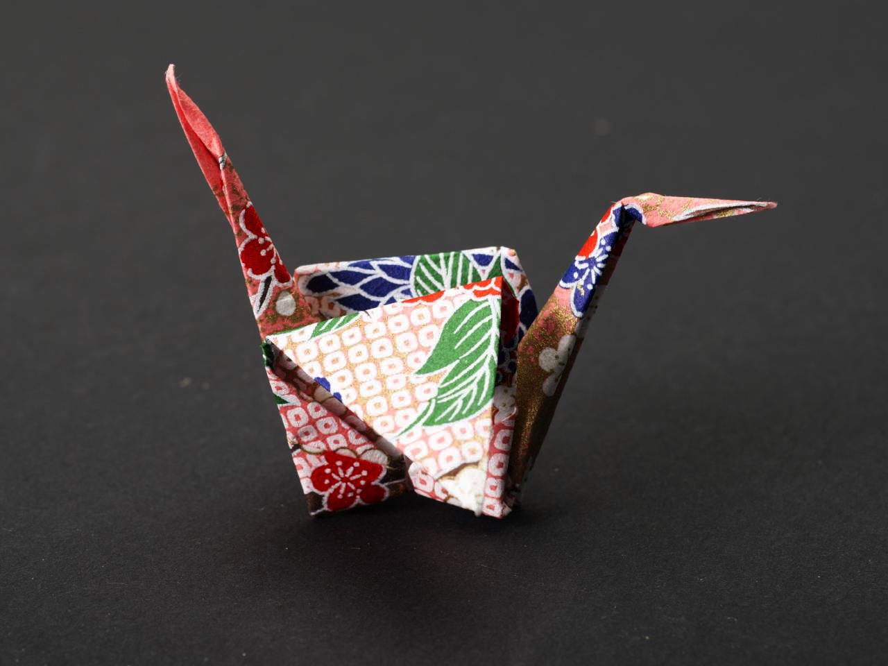 A red LED bulb is illuminated on a black background. The bulb is not connected to a socket.