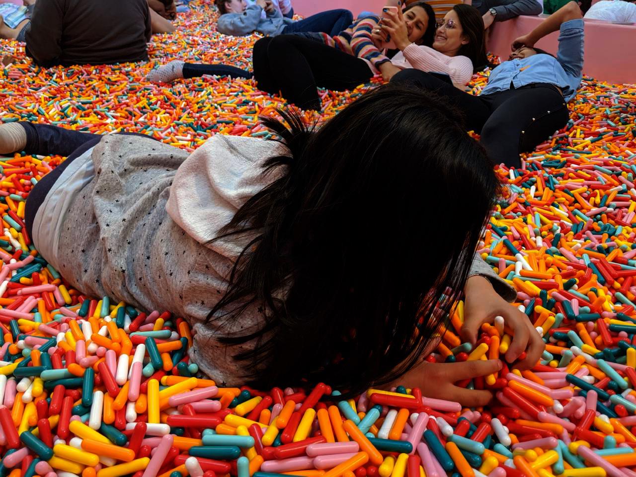 Visitors pose in a pool of oversize sprinkles at the Museum of Ice Cream in w:San Francisco.